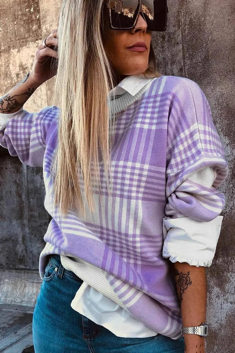 Lilac plaid print loose-fitting long sleeve sweater with ribbed trim on a hanger.