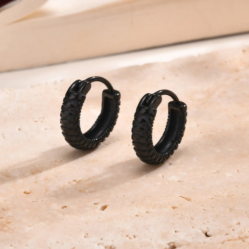 A pair of men's stainless steel earrings featuring a black snake pattern design, shown front-on.