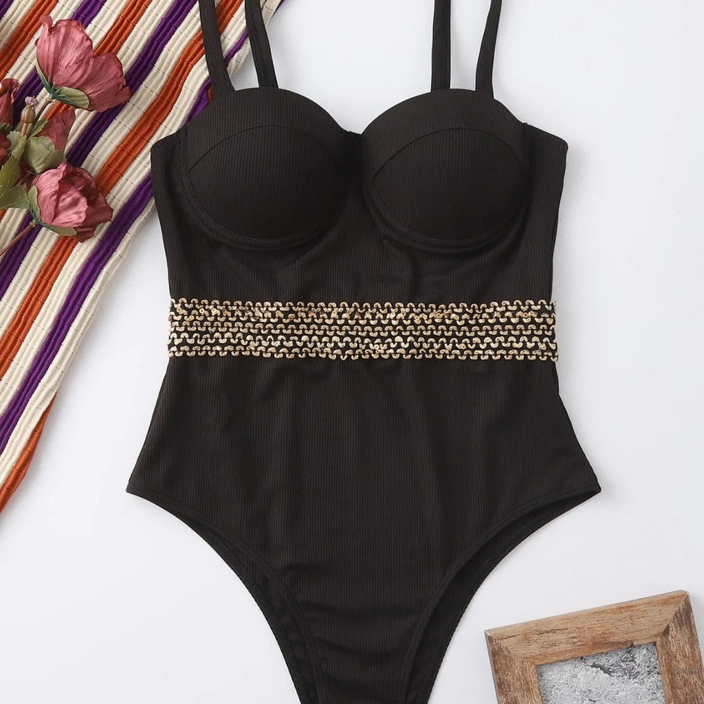 Black women's one-piece swimsuit with adjustable shoulder strap on a mannequin.
