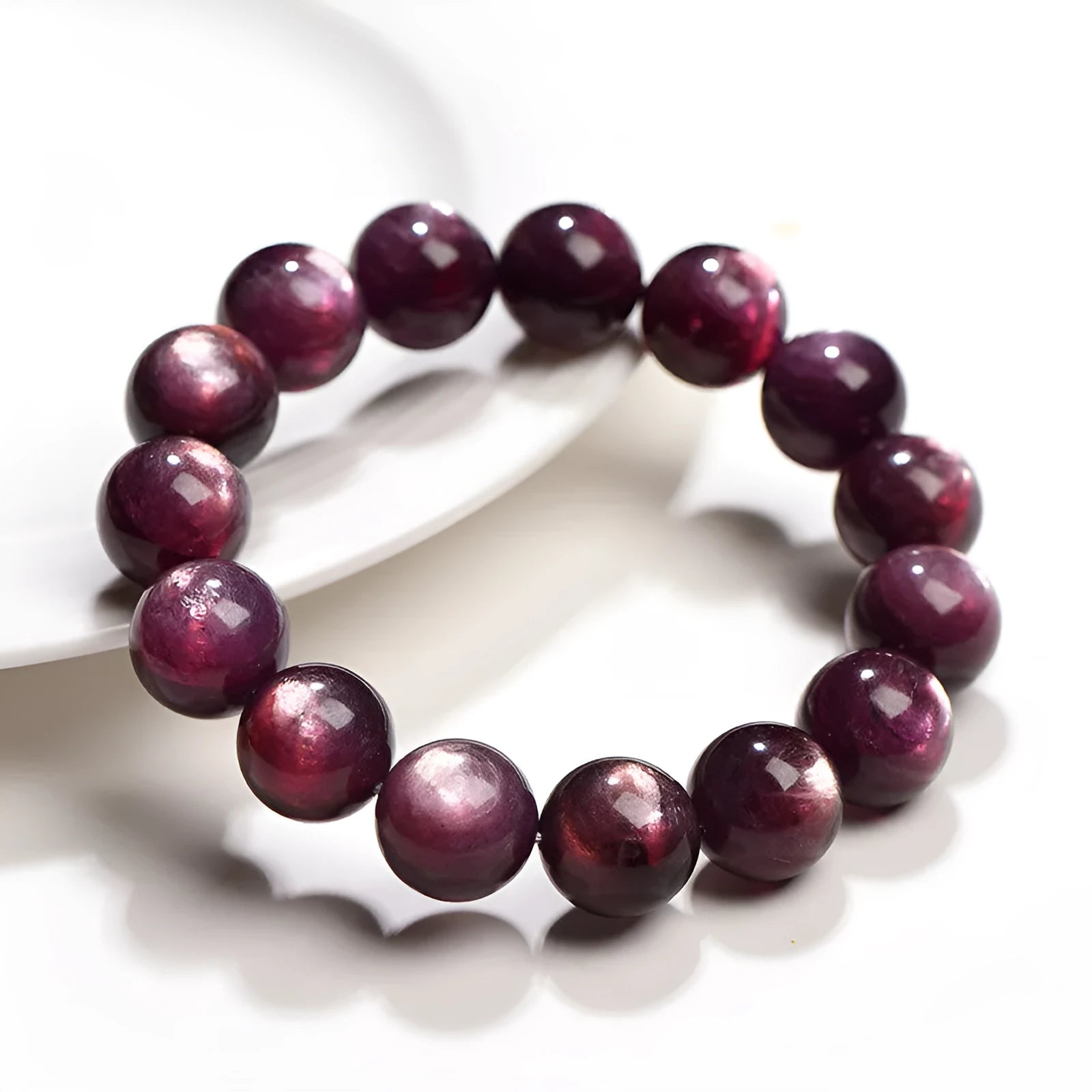 Natural purple lepidolite crystal bracelet with polished round beads, showing different size options.