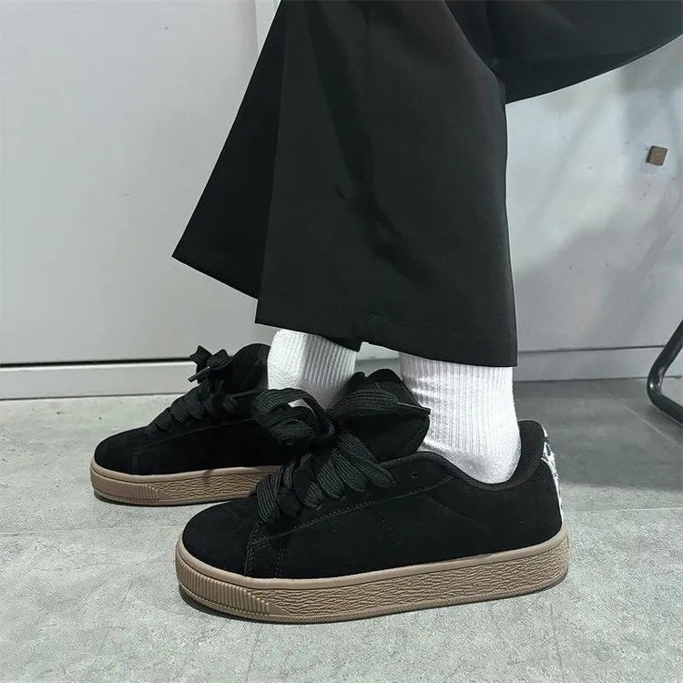 Black retro low-top sneakers with waterproof platform sole and round toe design
