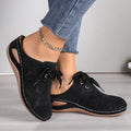 Women's black suede lace-up wedge slippers with hollow-out design and rubber sole.