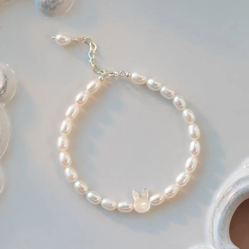 White pearl and 925 silver rabbit charm bracelet on a 16cm elastic string.