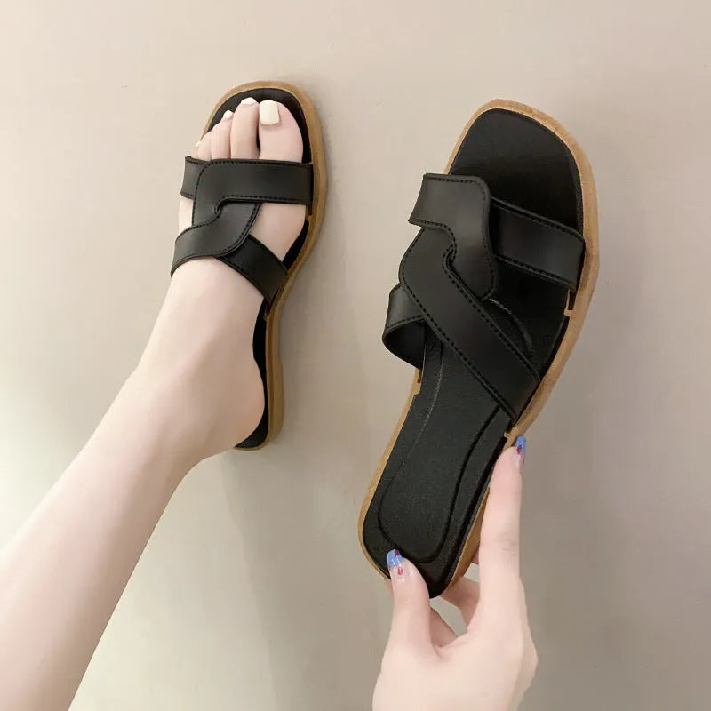 Women's PVC cross-strap flip flop sandals in light blue on a plain background.