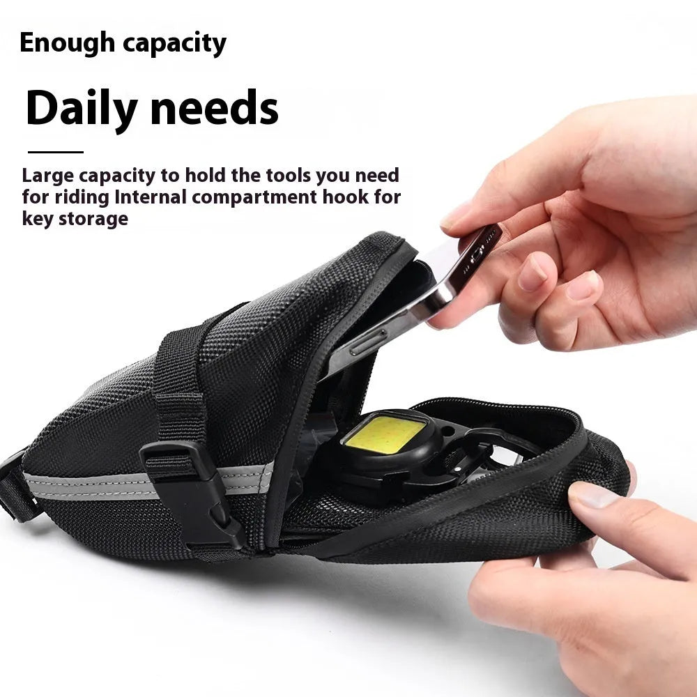 Black quick release bicycle saddle bag mounted under a bike seat