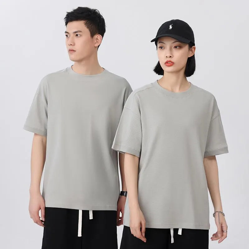 Breathable cotton pique short-sleeved T-shirt in a loose pullover style on a solid colour background.