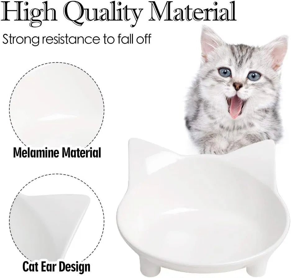 Shallow black and white melamine pet bowls with non-slip rubber bases on a kitchen floor.