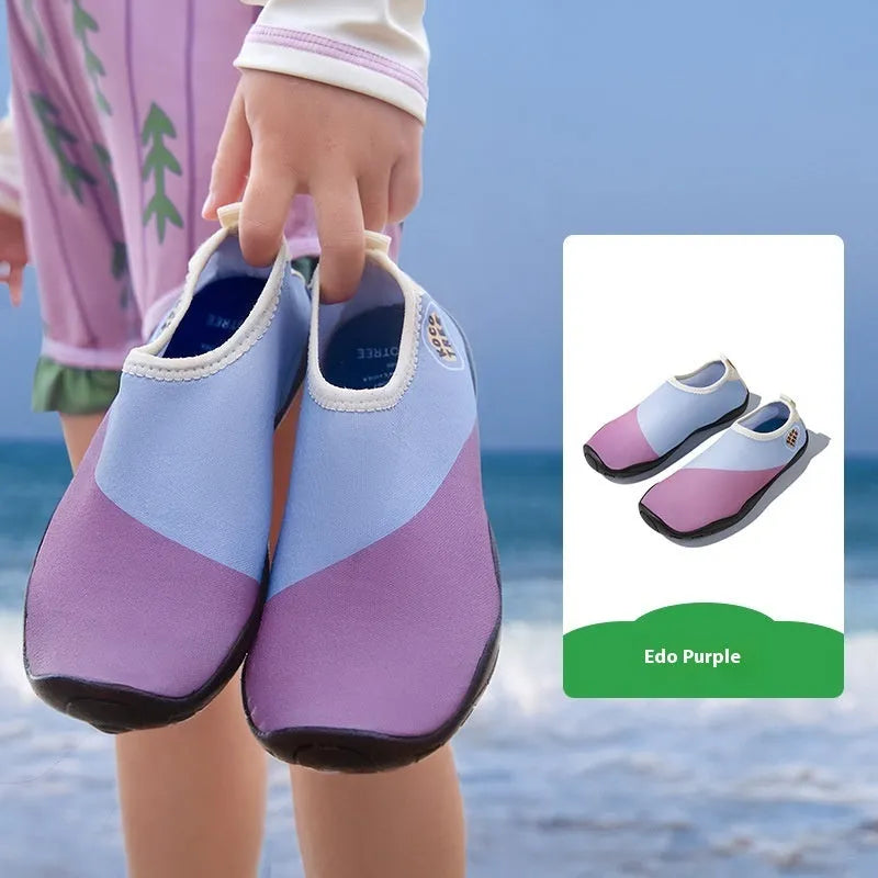 Children's anti-slip beach shoes in assorted colours with rubber soles and polyester fibre uppers.