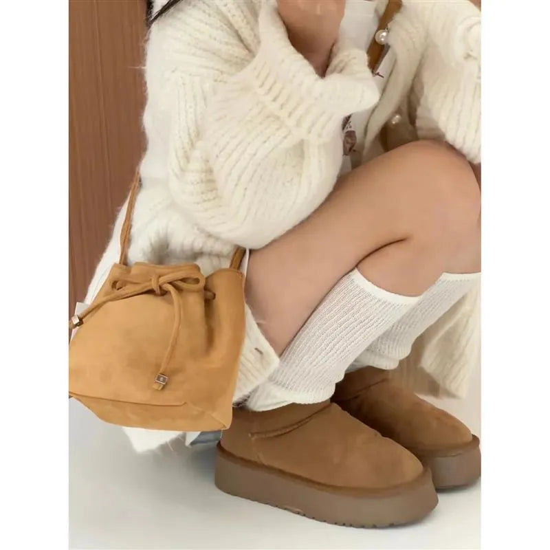 Brown suede crossbody shoulder bag with visible sewing line detail, retro style