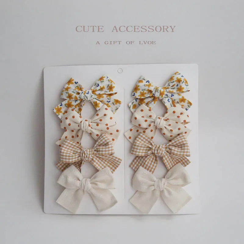 Dovetail bow hairclip set for children in cloth material with eight colour options