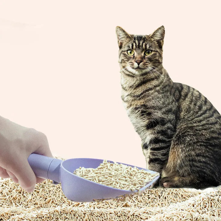 White ABS plastic cat litter scoop with a stand-up base and hidden bag storage compartment.