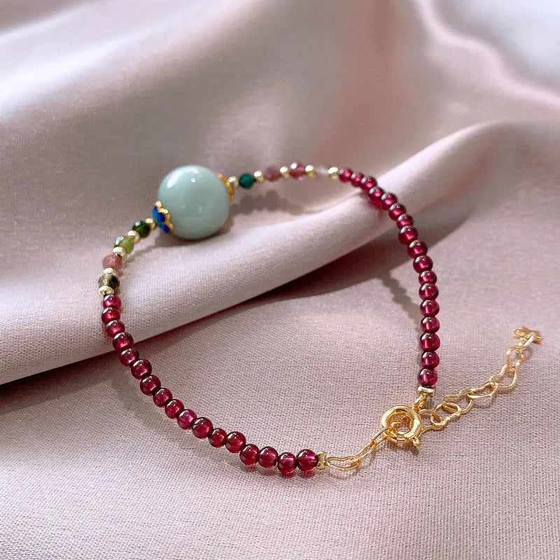 Simple aquamarine garnet bracelet with drop-shaped tourmaline stones and electroplated metal components