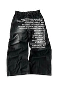 Man modelling black loose wide-leg straight cotton casual trousers with an elasticated waistband.