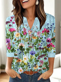 Woman wearing a loose-fit grey V-neck top with a raised white 3D geometric pattern on the front.