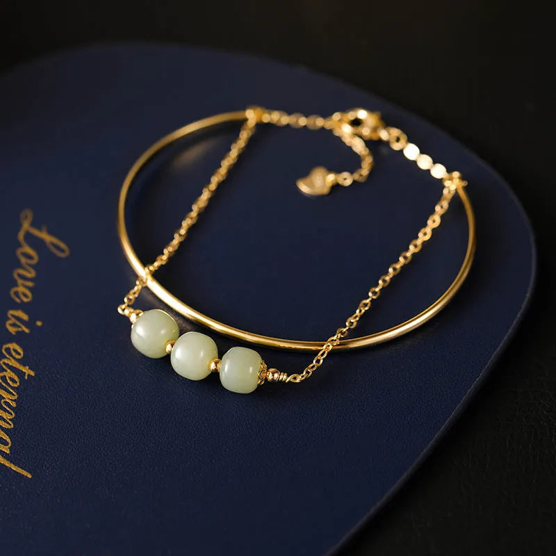 Women's Hetian jade lucky beads bracelet with gold inlay in a fake two pieces style.