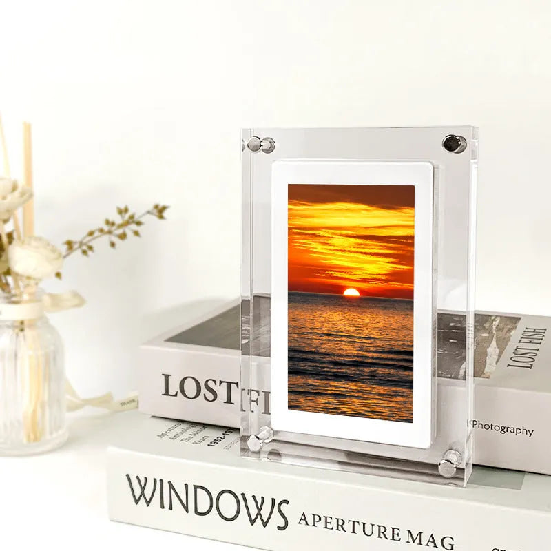 White vertical digital picture frame with 5-inch screen on a table