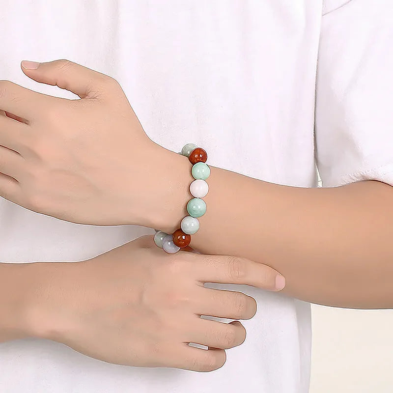 Close-up of a women's bracelet with round 13mm Myanmar jade beads in three colours.