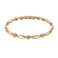 Golden hollow carved copper bracelet with U-shaped design on a wrist.