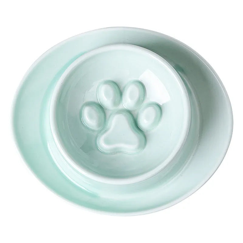Green ceramic slow feed pet bowl with raised interior ridges and a non-slip black rubber base.