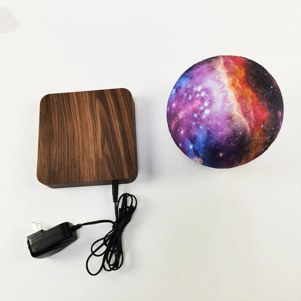 Square walnut coloured levitating moon lamp with galaxy light effect rotating above a circular base.