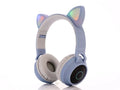 Cartoon cat ears wireless Bluetooth gaming headset shown in one of five colours: green, light blue, pink, purple, or skin tone.