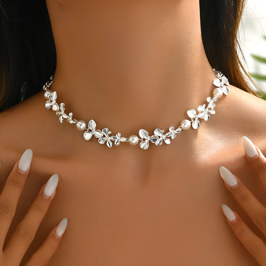 Bright silver alloy flower pearl curved needle clavicle necklace on neutral background