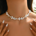 Bright silver alloy flower pearl curved needle clavicle necklace on neutral background