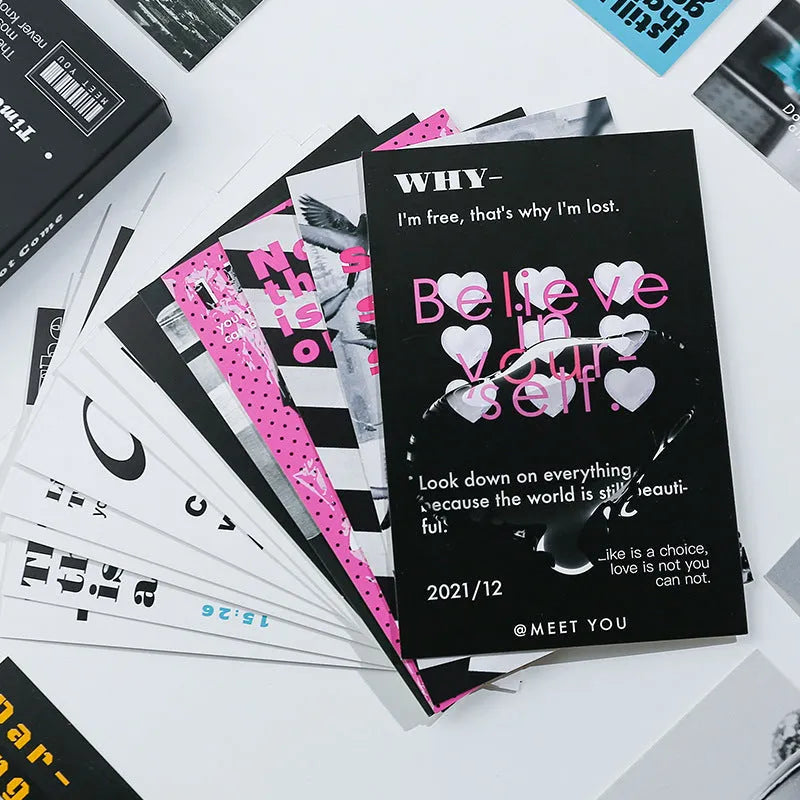 Box of fresh printed postcards showing two creative greeting card designs.