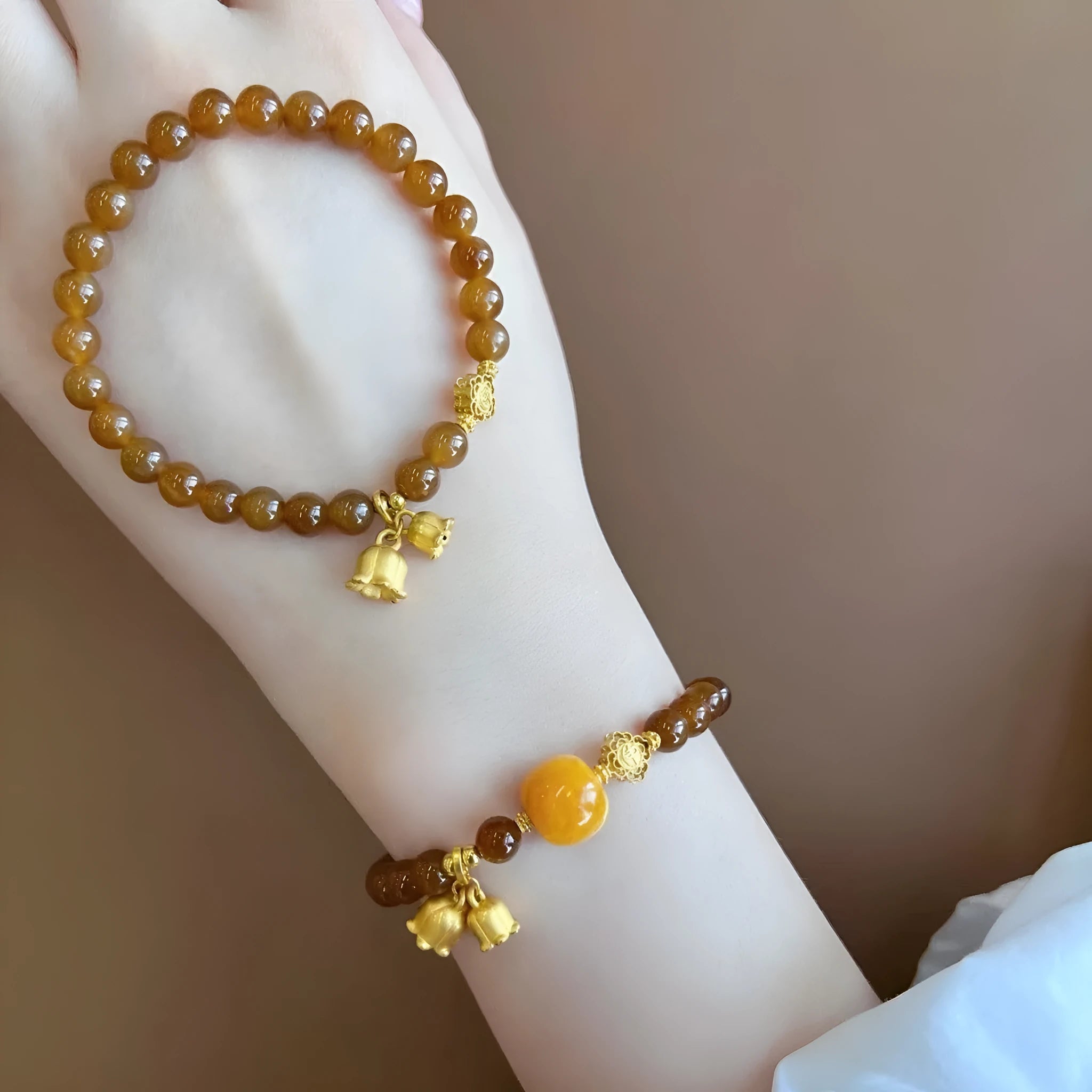 Women's caramel beeswax Lily charm bracelet with electroplated finish and New Chinese style design.
