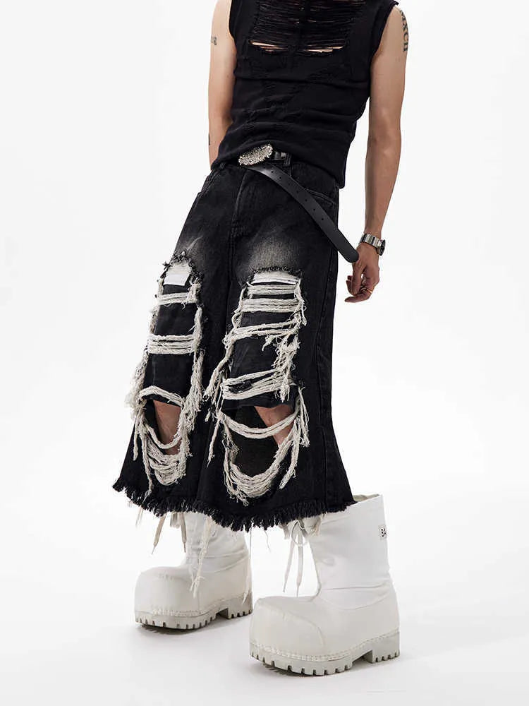 Black women's cropped wide-leg jeans with a mid-high waist and ripped patch details on a loose fit.