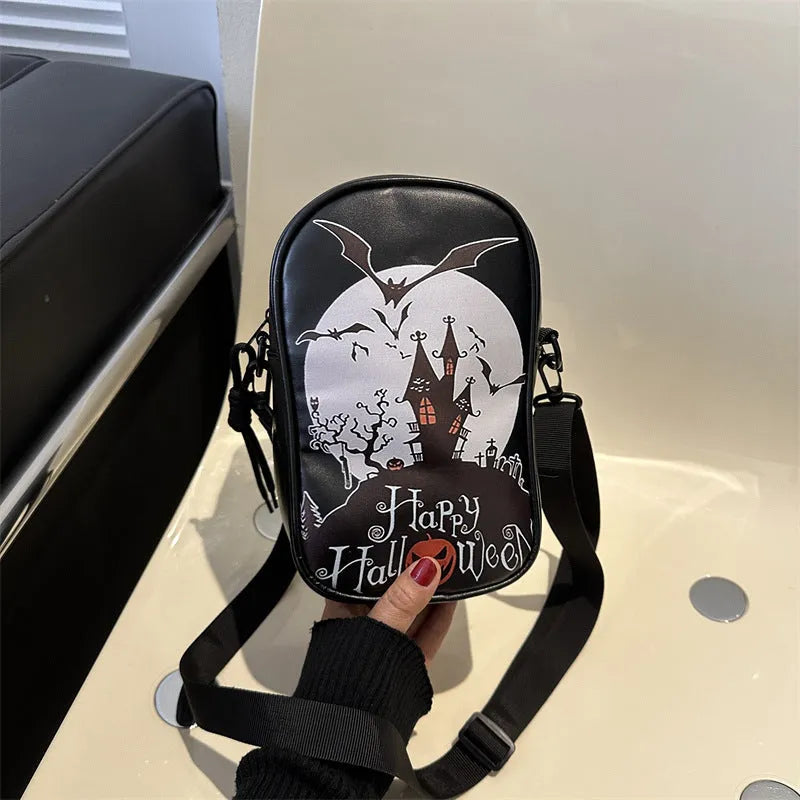 Black Halloween crossbody bag with orange pumpkin, white ghost, and black bat graffiti print, shown on adjustable strap.