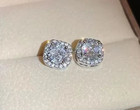 A pair of square geometric alloy earrings with diamond treatment in silver colour.