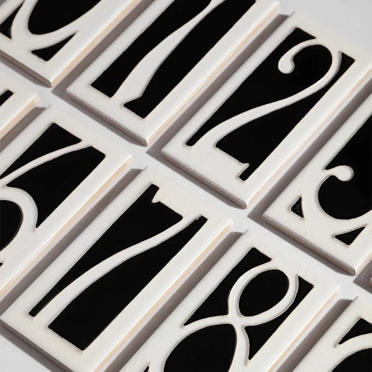 Handmade white ceramic door number plate with black enamel numeral 5, showing 76mm by 152mm dimensions and retro style.