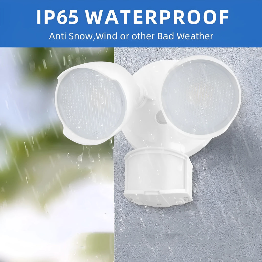 White outdoor LED security flood light with motion sensor mounted on a wall bracket