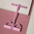 White yoga four piece set showing leg stretcher, yoga ring, pedal chest expander, and figure eight tension rope