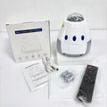 Space capsule shaped USB projection lamp showing galaxy light effect on a wall