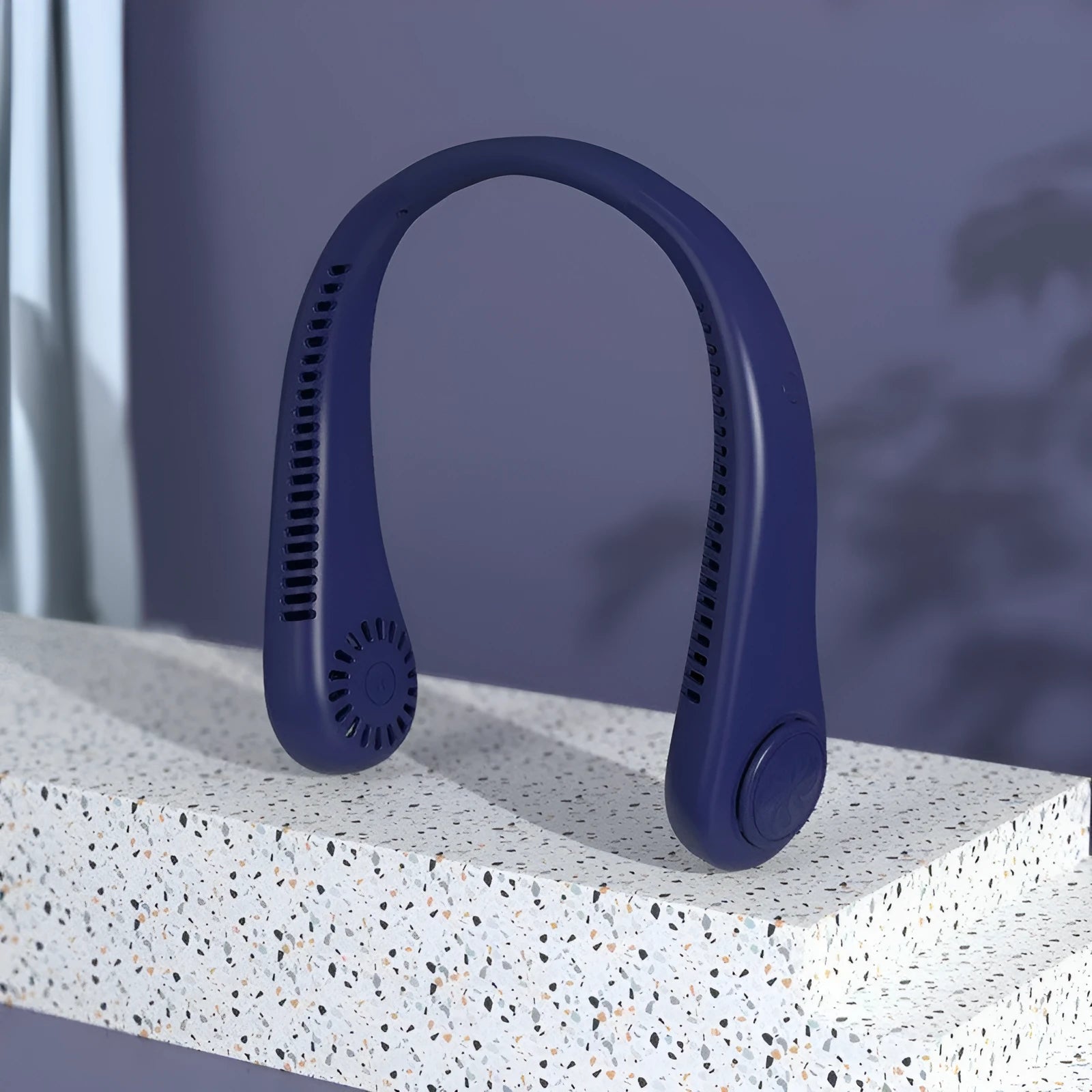 Blue portable bladeless neck fan hanging around a person's neck, showing the USB port.