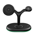 Black magnetic wireless charging stand holding an iPhone vertically on a desk