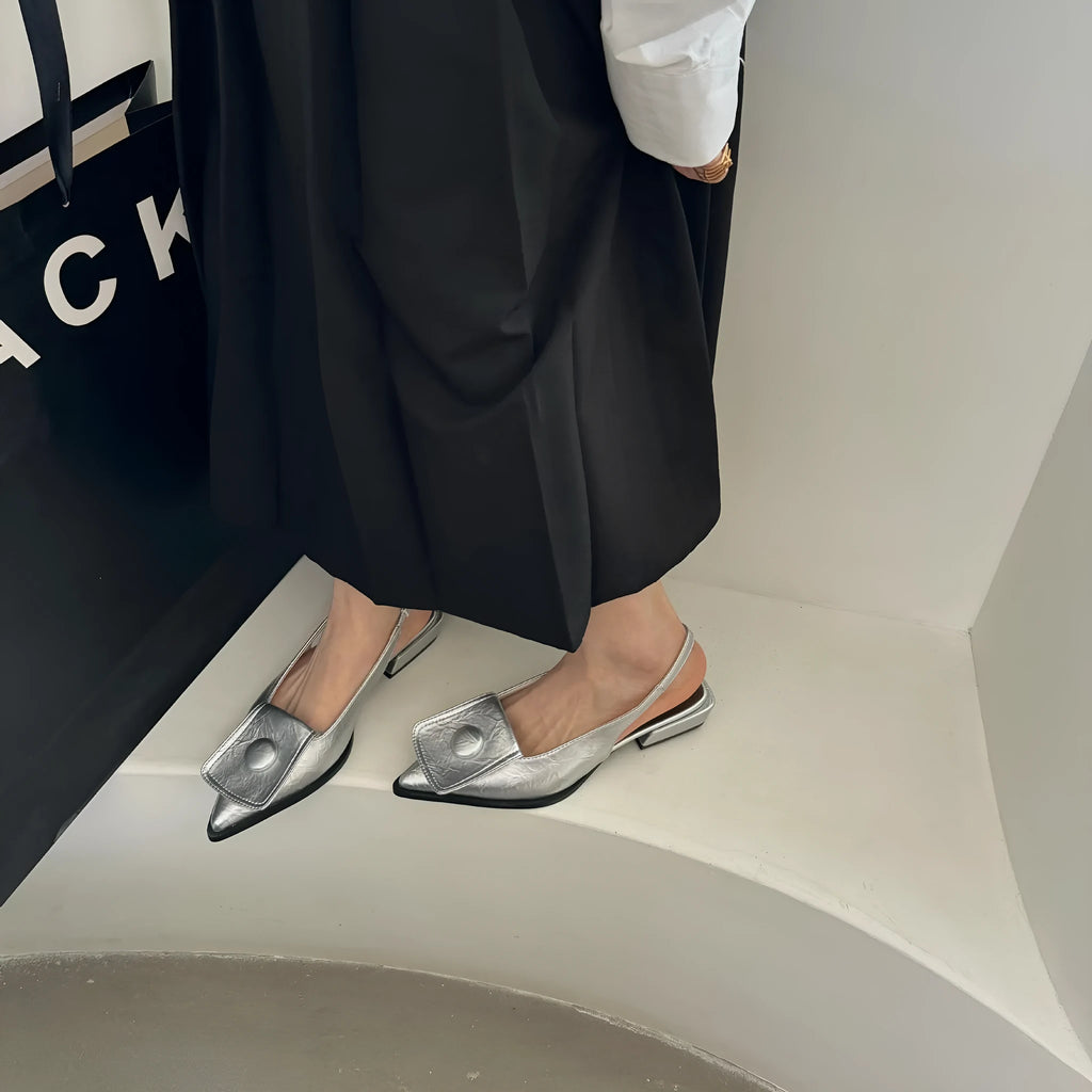 Women's low-heel closed toe sandals with a pointed toe and a back strap in apricot colour.