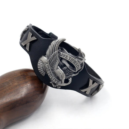 Black leather geometric bracelet with alloy eagle watch-buttom closure on wrist