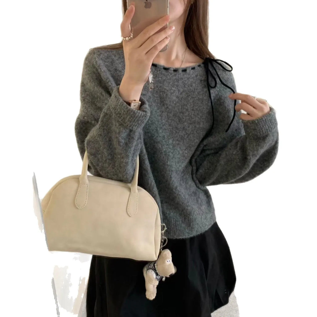 Grey loose-fitting women's pullover jumper on a hanger.