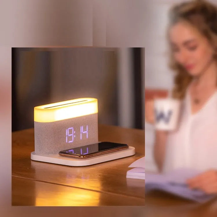 White wireless charging table lamp with integrated alarm clock on bedside table