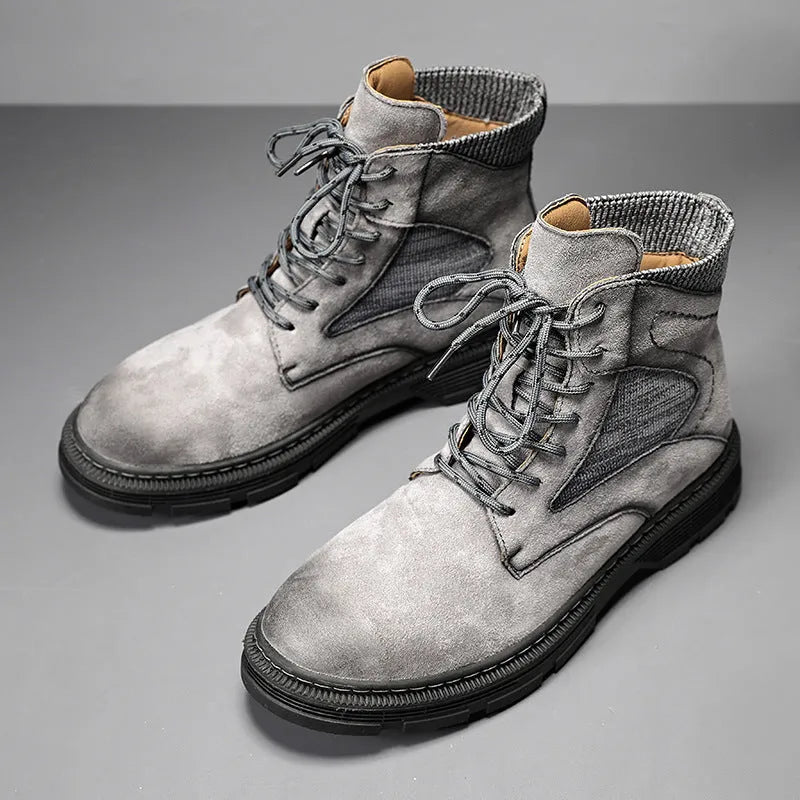 Men's frosted brown Martin boots with round toe and thick rubber sole on a wooden surface.