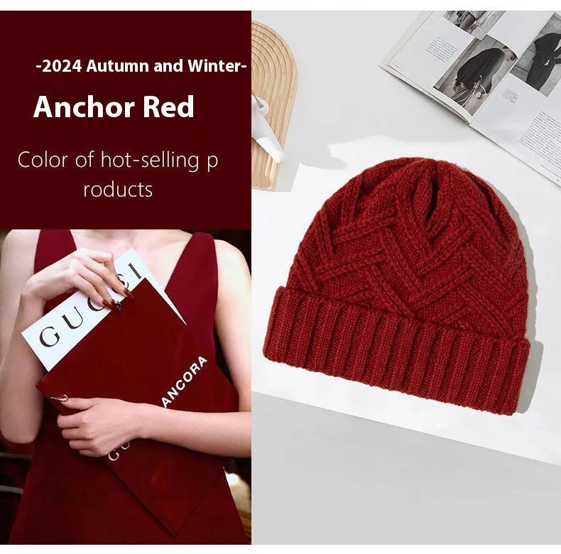 Woman wearing a knitted wool beanie with a dome crown and tribal totem pattern in Ankela Red.