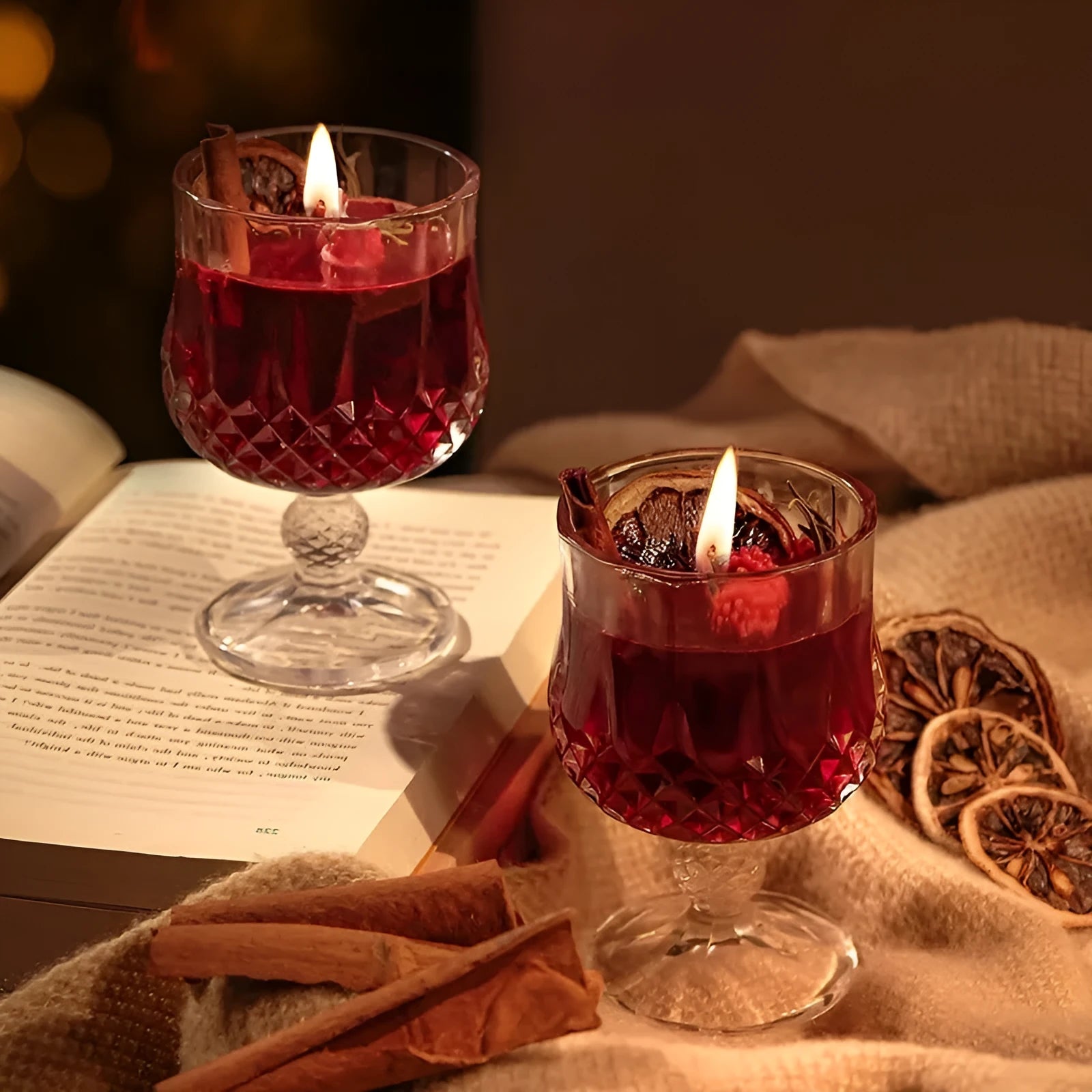 Glass wine goblet shaped container holding a French mulled wine scented aromatherapy candle.