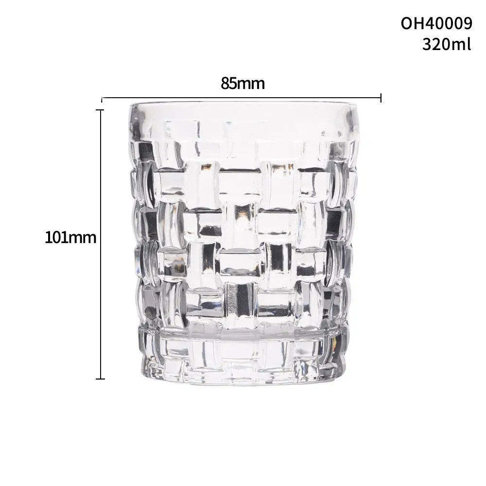 Clear crystal whiskey shot glass with thick bottom base on a table.