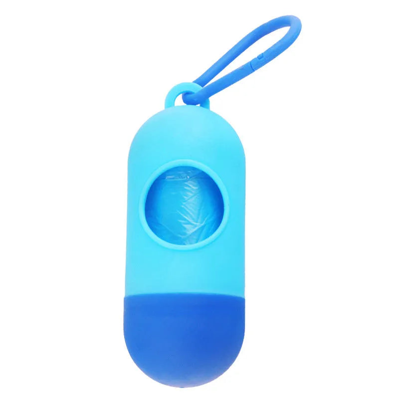 Black dog waste bag holder with Velcro strap and metal hook, showing bag dispenser slot.