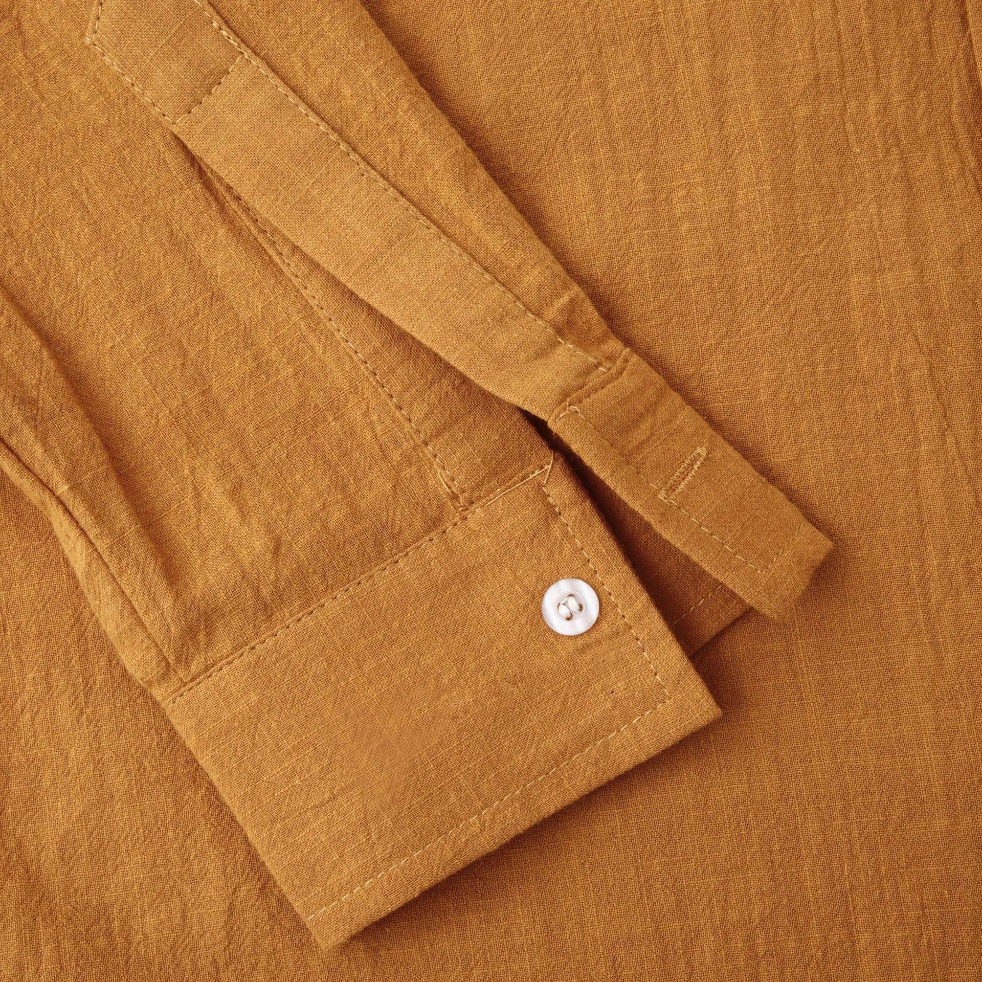 Men's brown slim cotton blend shirt with long sleeves on mannequin showing fitted design