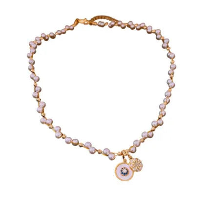 Gold electroplated necklace with round zircon and imitation pearl geometric pendant on an adjustable chain.
