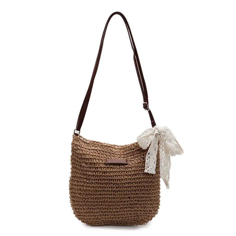 Women's woven straw messenger bag in khaki colour, showing hollowed texture and single shoulder strap.